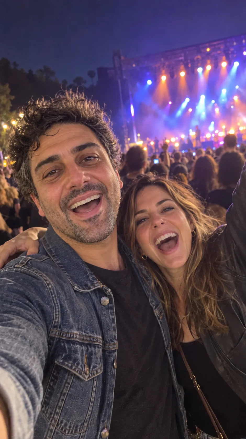 AI-generated example of a future self: a man taking a selfie with his wife at an outdoor concert at night.